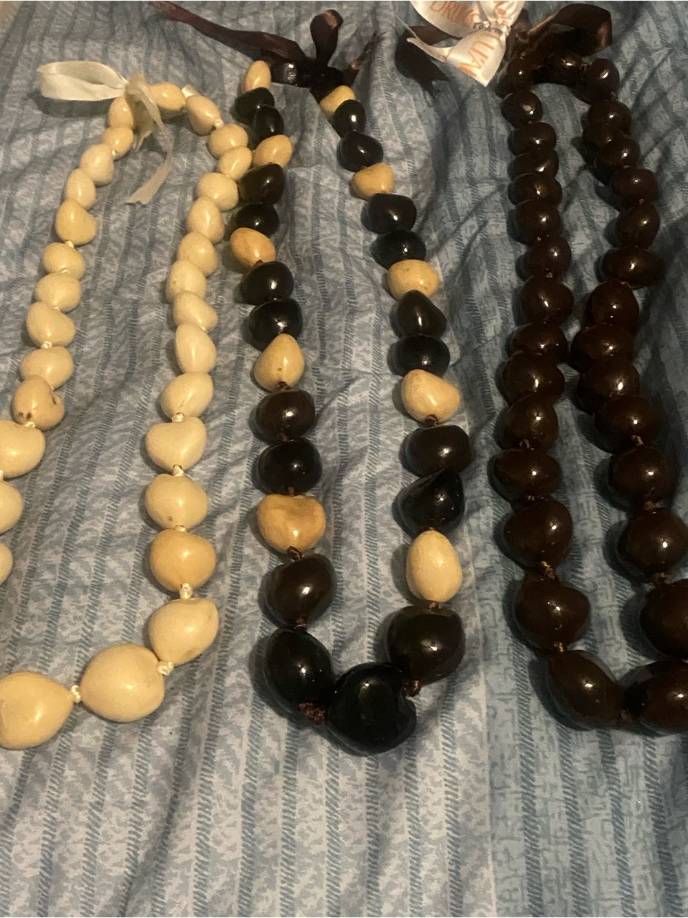 3 Hawaiian Kukui Nut Leis in Brown, Black and Cream, unisex, worn for celebratio